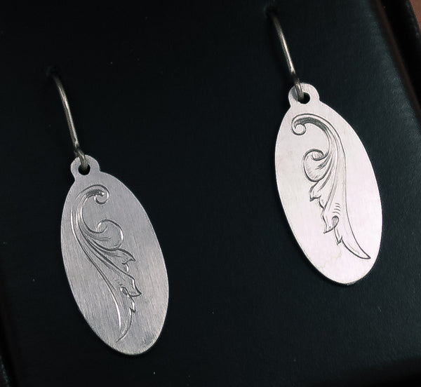 Hand-engraved titanium earrings by Podforge